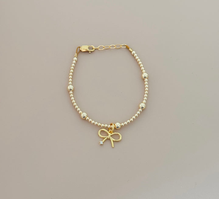 14k gold filled beaded bracelet with bow charm