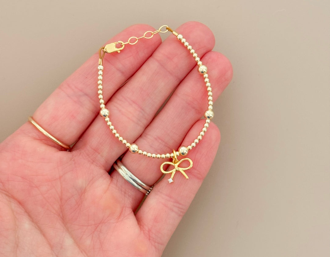 14k gold filled beaded bracelet with bow charm