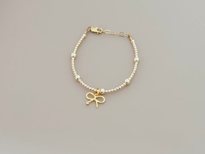 14k gold filled beaded bracelet with bow charm